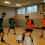 Alaska high school soccer players training indoors in a gymnasium during winter with snow outside
