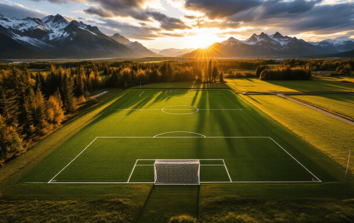 An Alaska high school soccer field with mountains in the background during sunset