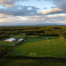 Aerial view of a multi-field soccer complex in Alaska surrounded by forest