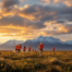 Young female soccer players training on a remote tundra field with mountains in the background